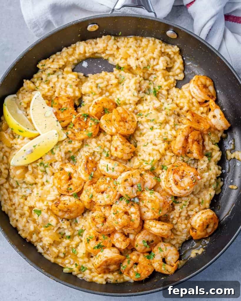 Golden Garlic Shrimp Risotto 2 top view of shrimp and rice risotto in a black skillet