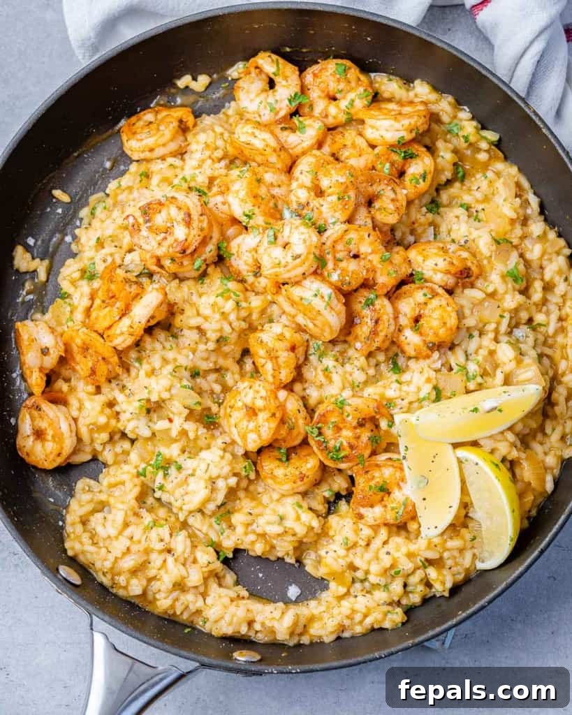 Golden Garlic Shrimp Risotto 8 top view risotto topped with shrimp with lemon granishes