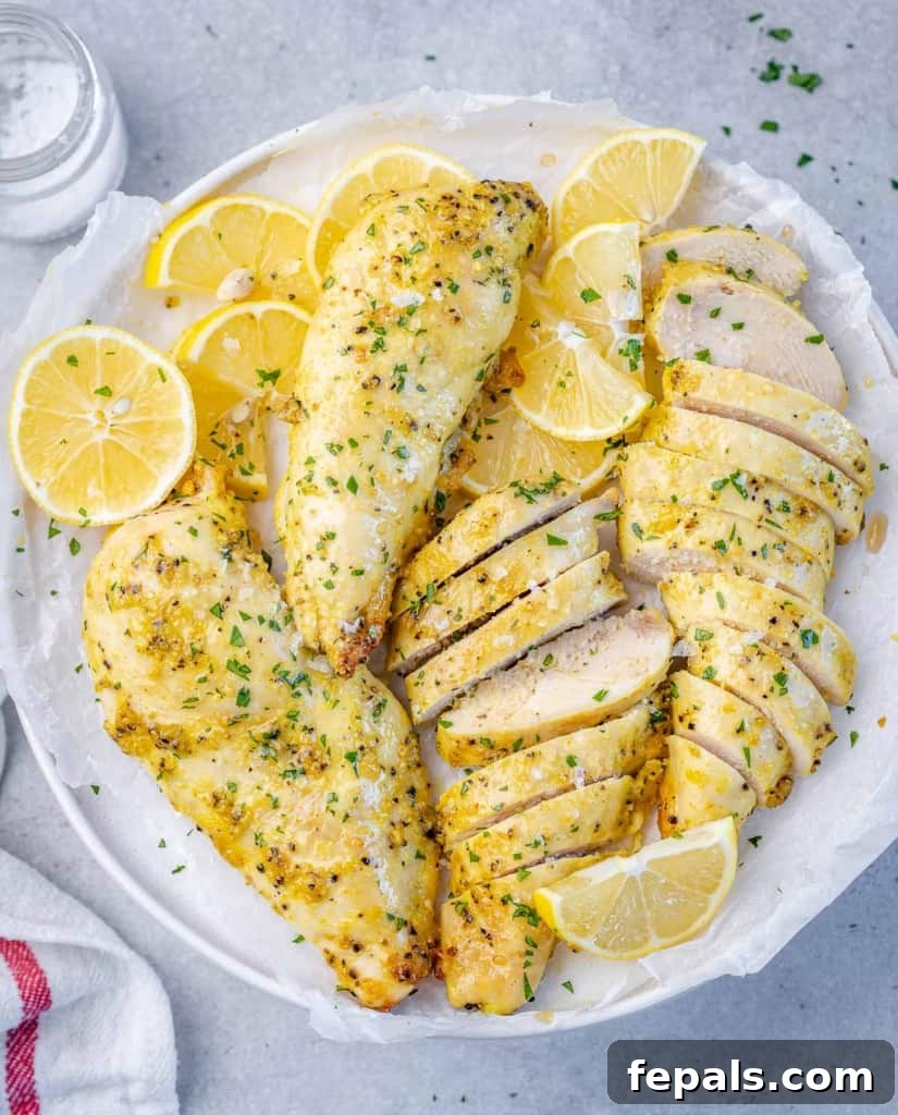 top view air fryer chicken breast on a white plate. a couple of chicken breast sliced