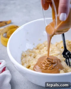 Wholesome Oat Energy Bars 7 Jar pouring peanut butter into a bowl with mashed bananas.