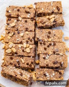 Wholesome Oat Energy Bars 9 baked oatmeal bars on parchment paper with chocolate chips and peanuts.