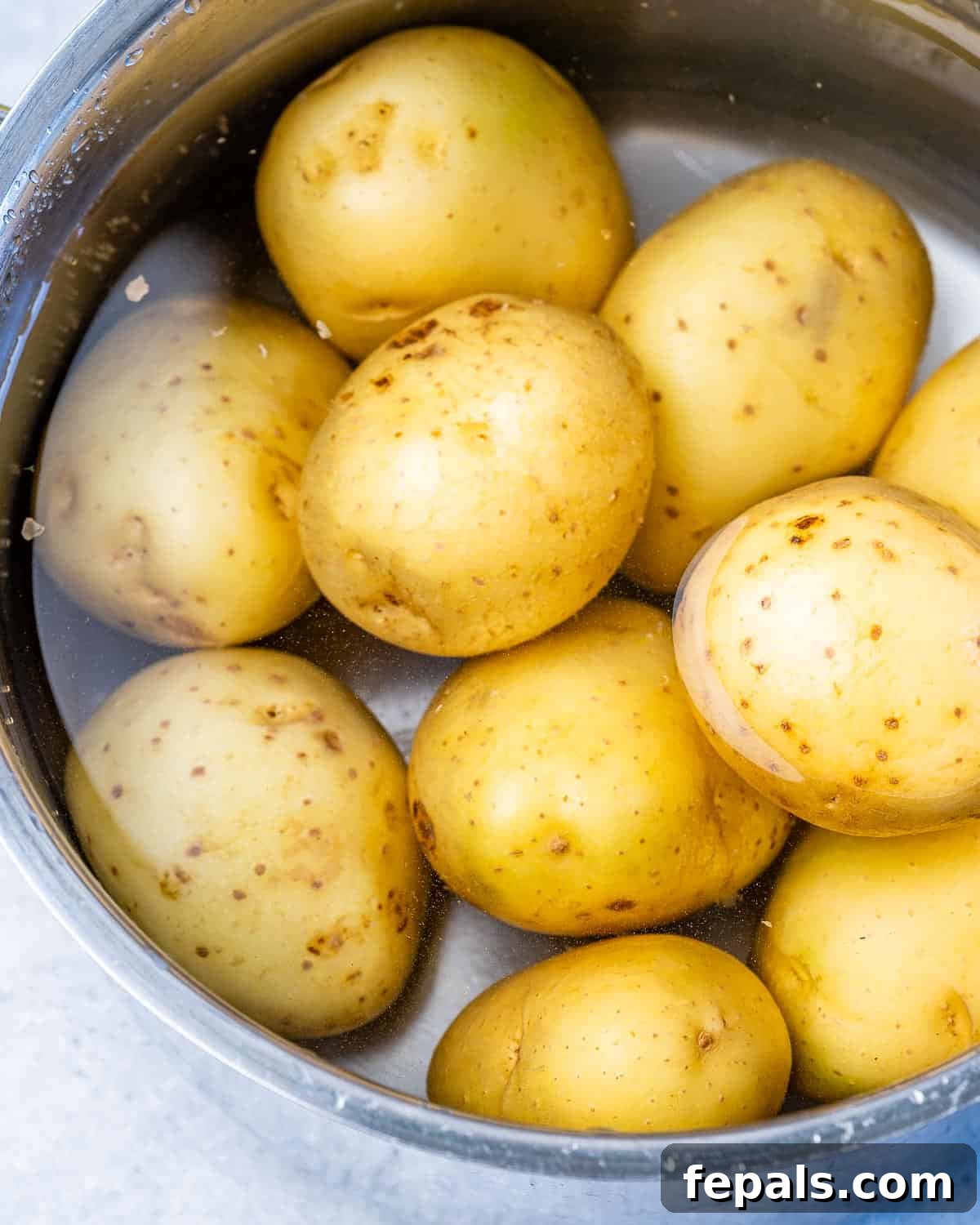 Healthy Smashed Potatoes bowl of potatoes in water
