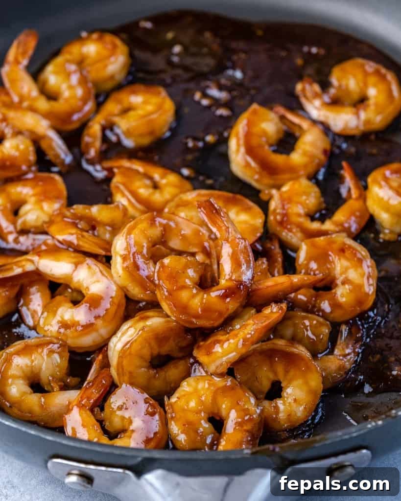sautéed teriyaki shrimp in a black skillet