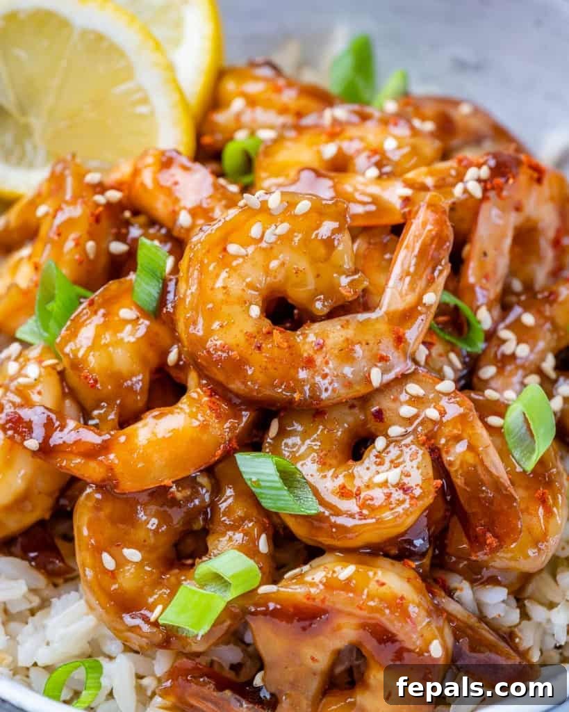 close up teriyaki shrimp with green onion garnishes