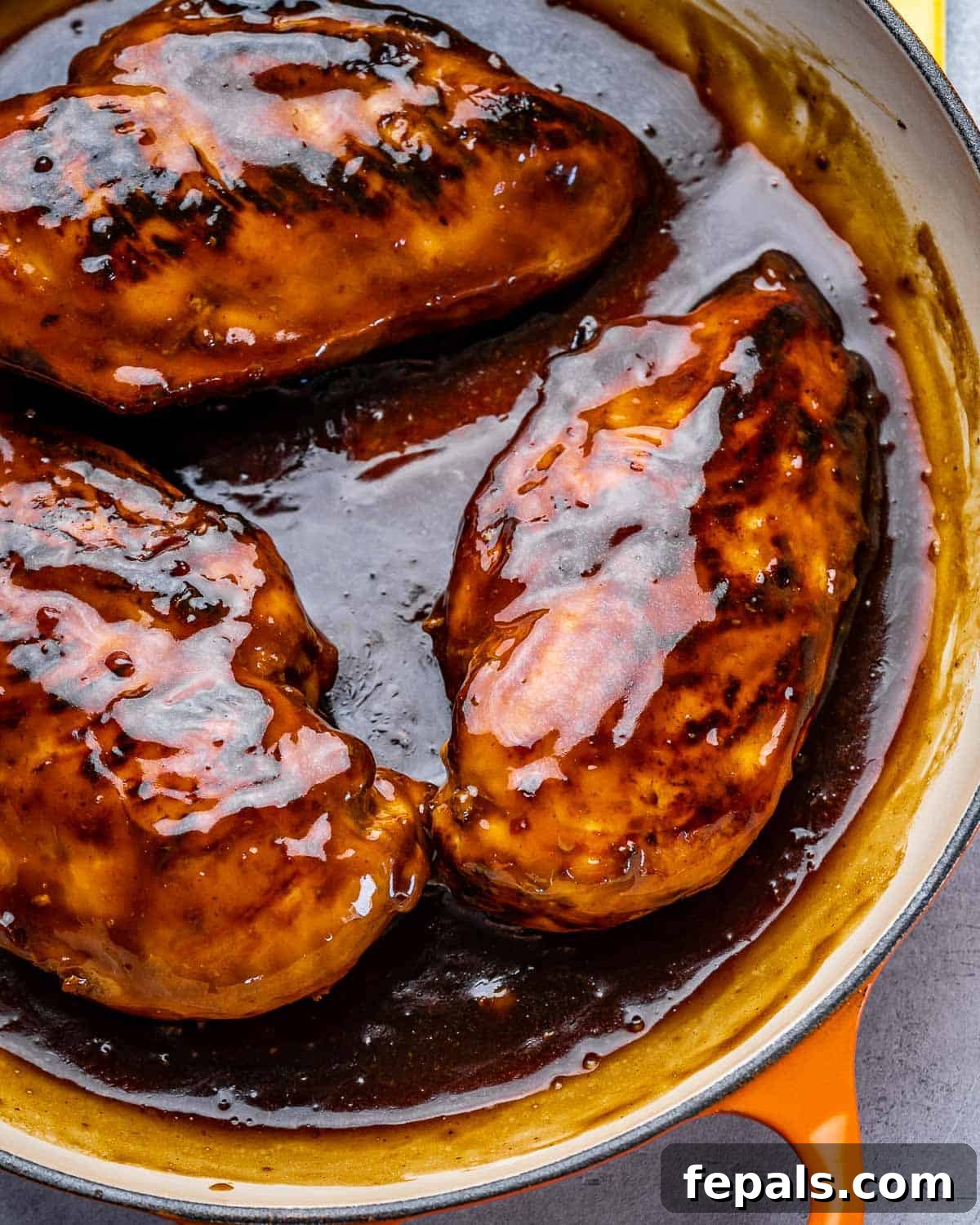 Asian chicken breasts in pan with sauce