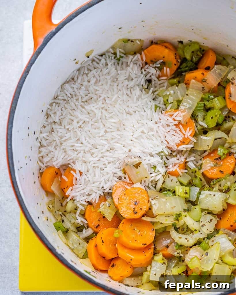 Velvety Chicken and Rice Comfort 5 rice added over sauteed veggies to make chicken soup