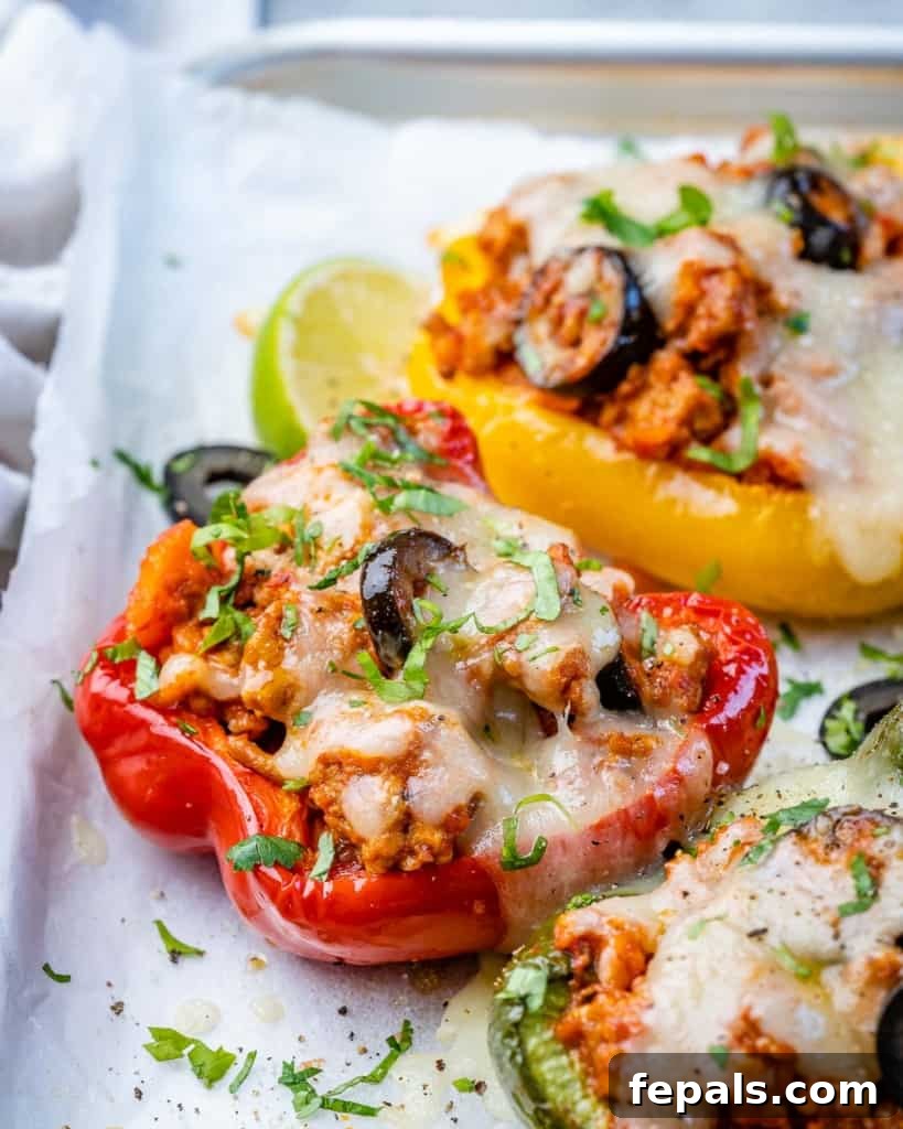 side shot of stuffed bell peppers topped with melted cheese