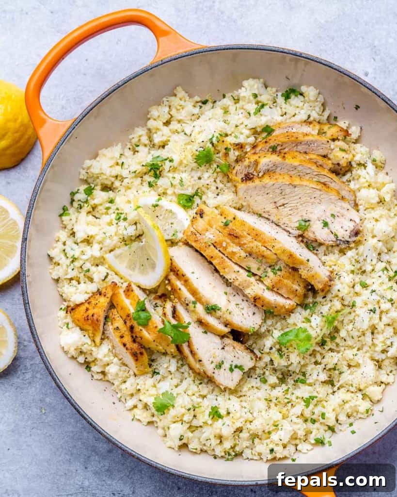 Golden Pan-Seared Lemon Garlic Chicken 2 Top view of perfectly sliced lemon garlic chicken breast served over cauliflower rice in an orange skillet