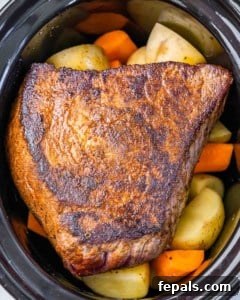 pot roast with veggies in the slow cooker before being cooked