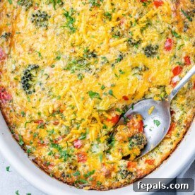 Savory Broccoli Cheddar Breakfast Bake 11 top view of broccoli cheese breakfast casserole with spoon in it