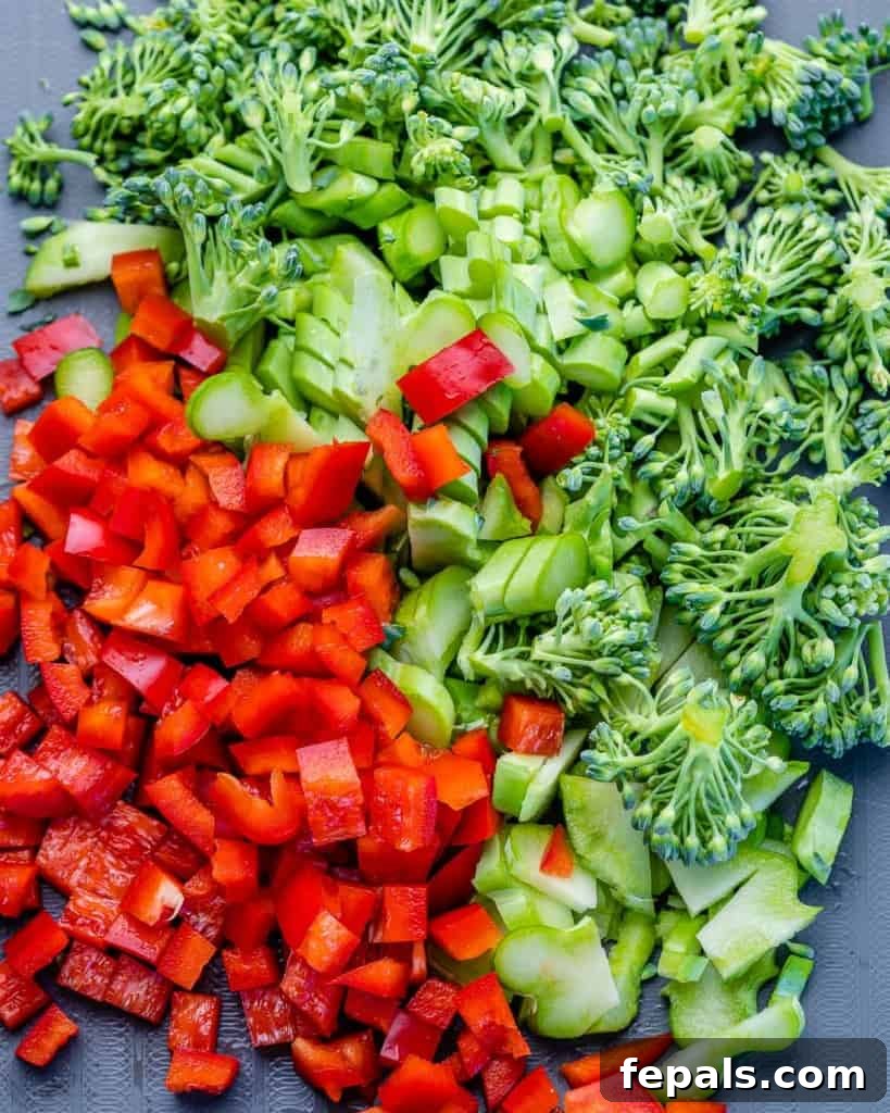 Savory Broccoli Cheddar Breakfast Bake 5 chopped broccoli and red peppers on a cutting board
