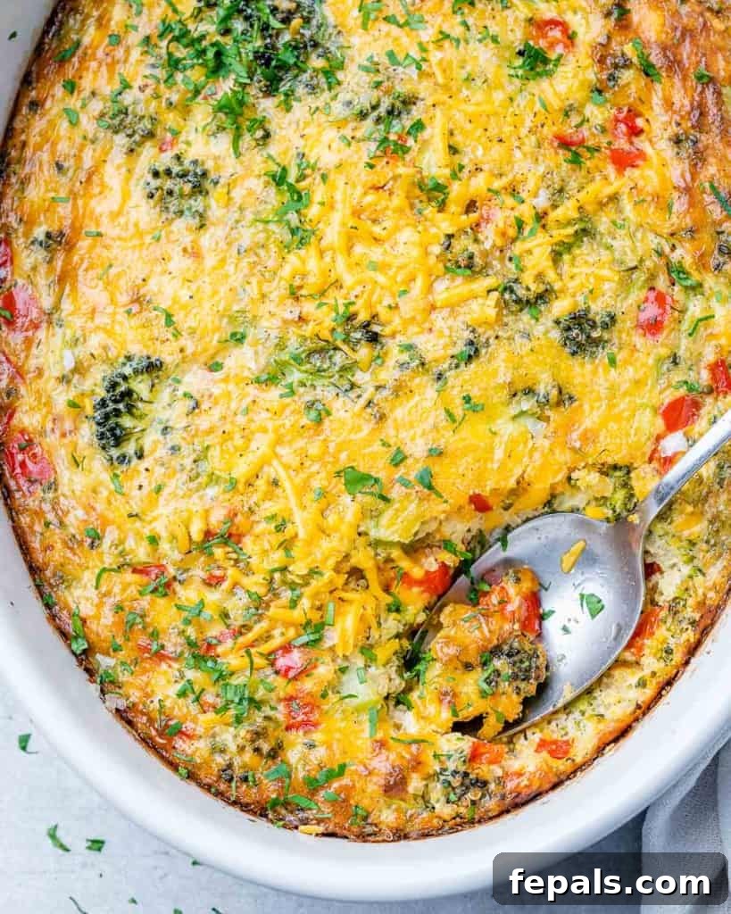 Savory Broccoli Cheddar Breakfast Bake 8 top view of spoon in breakfast broccoli casserole in a white dish