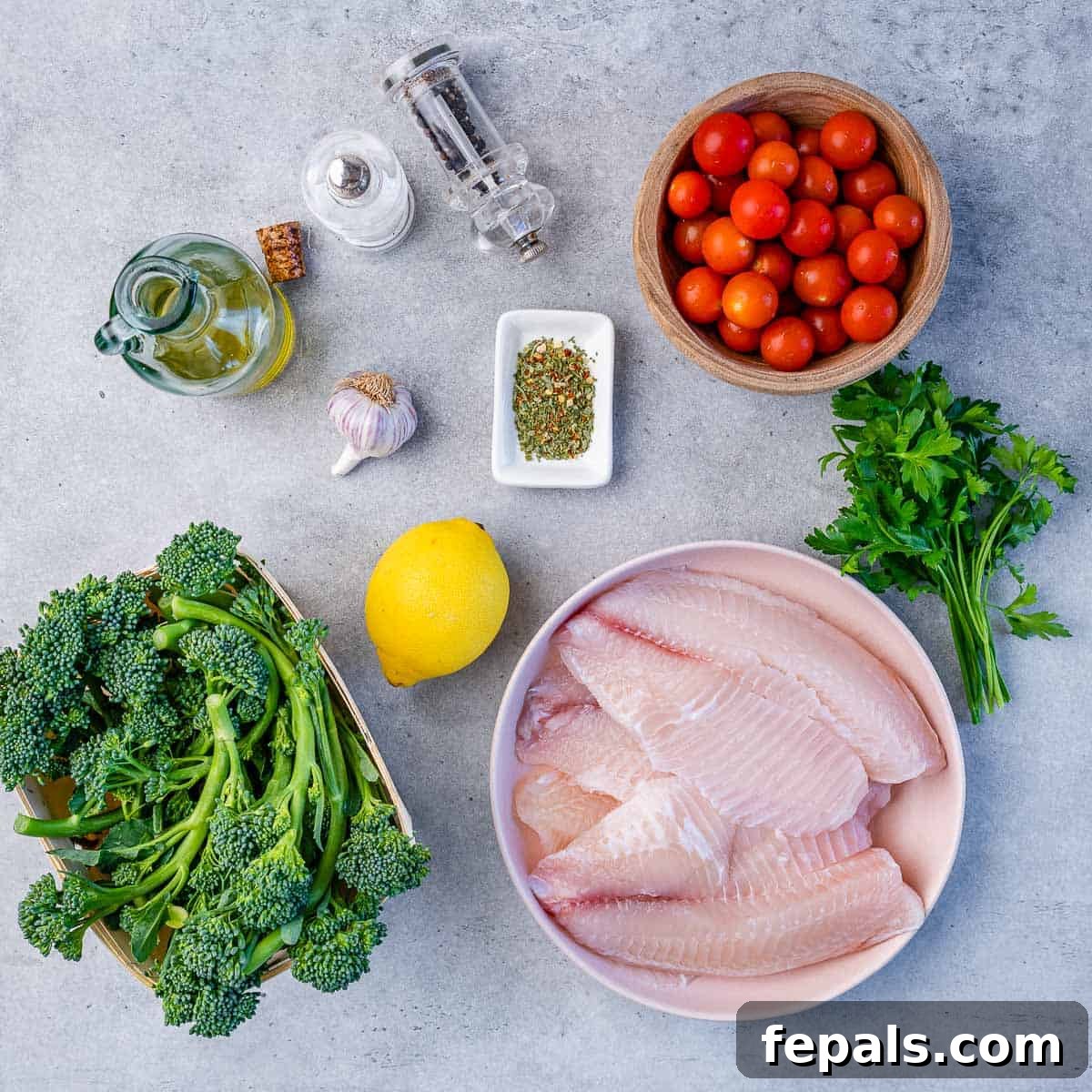 Healthy Baked Tilapia Recipe tomatoes, salt, pepper, oil, lemon, garlic, Italian seasoning, tilapia fish fillets, broccolini, parsley