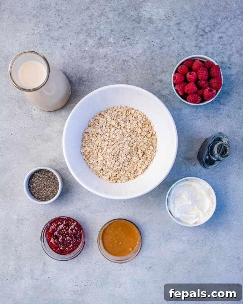 Dreamy PB&J Overnight Oats 4 ingredients to make the peanut butter and jelly overnight oats, including oats, chia seeds, yogurt, milk, peanut butter, and raspberries