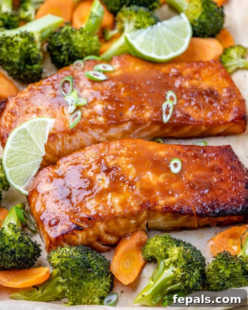 Umami Miso Salmon 7 side shot of baked miso glazed salmon fillets with roasted broccoli and carrots on a sheet pan