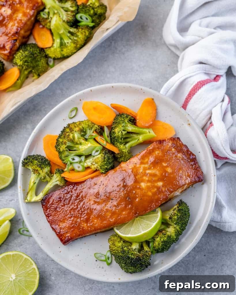 Umami Miso Salmon 10 top view of two miso glazed salmon fillets on a white plate with roasted broccoli and carrots