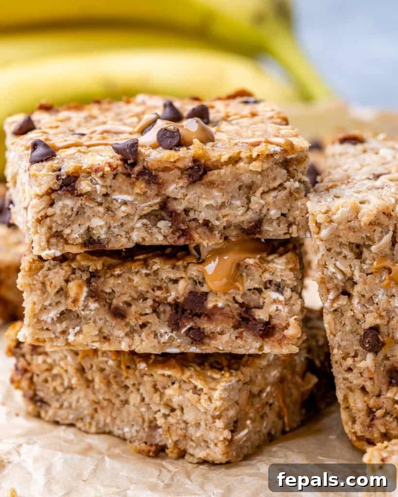 Stacked squares of chocolate chip oatmeal bars, showing their soft texture and embedded chocolate chips.