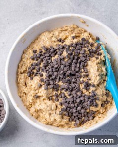 chocolate chips added over a bowl or oatmeal mixture before baking