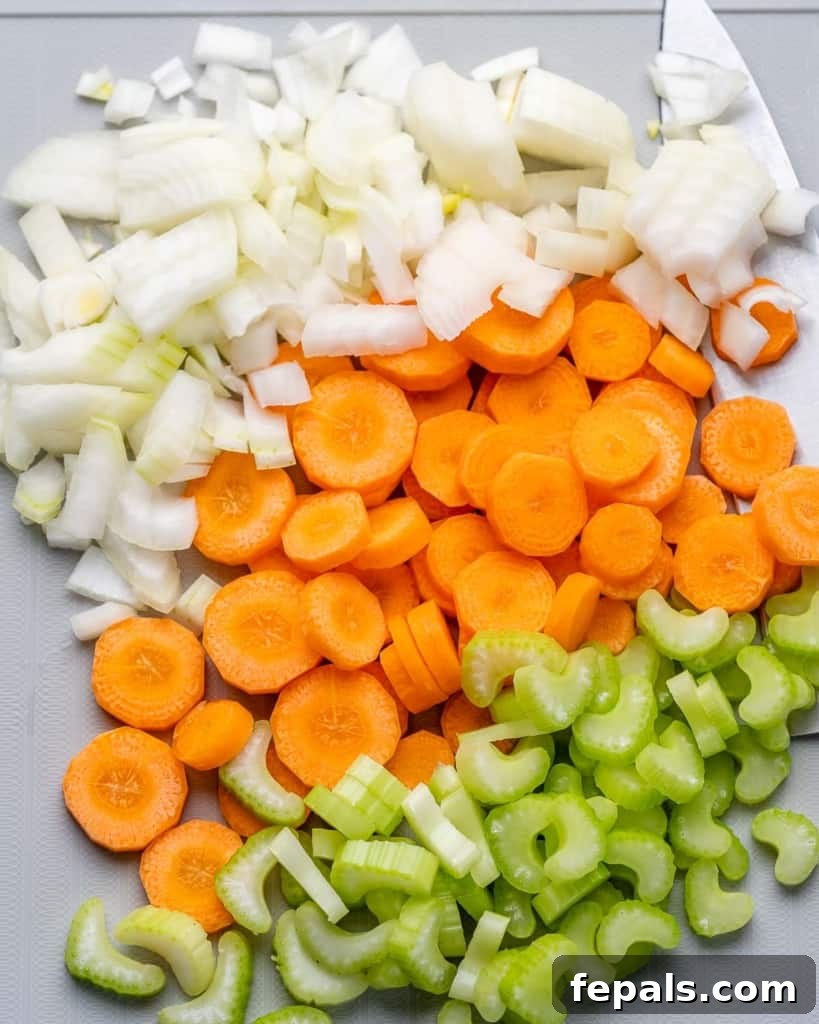 chopped veggies in a pot for the soup: onion, carrots, and celery