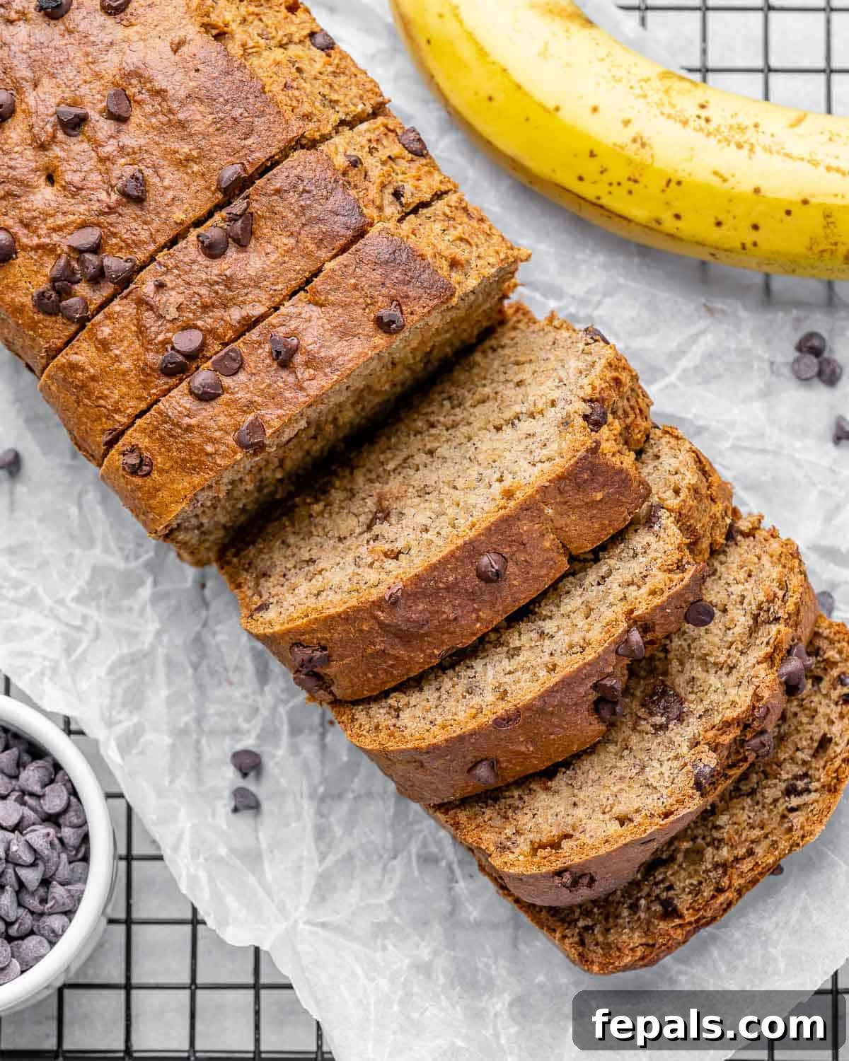 Top view of beautifully sliced vegan banana bread, showcasing its moist texture and chocolate chips.