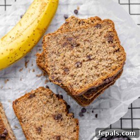 Top view of sliced banana bread stacks with a side of banana