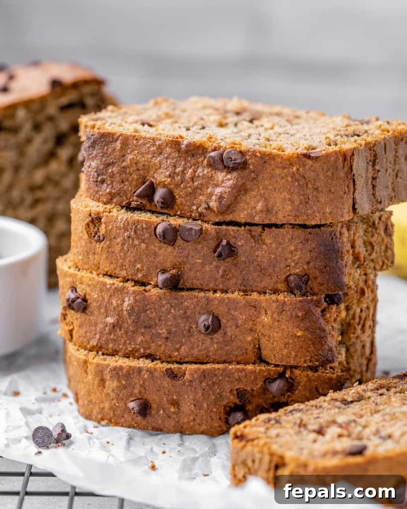 Close-up of fluffy, moist slices of vegan banana bread, showing the texture and chocolate chips.