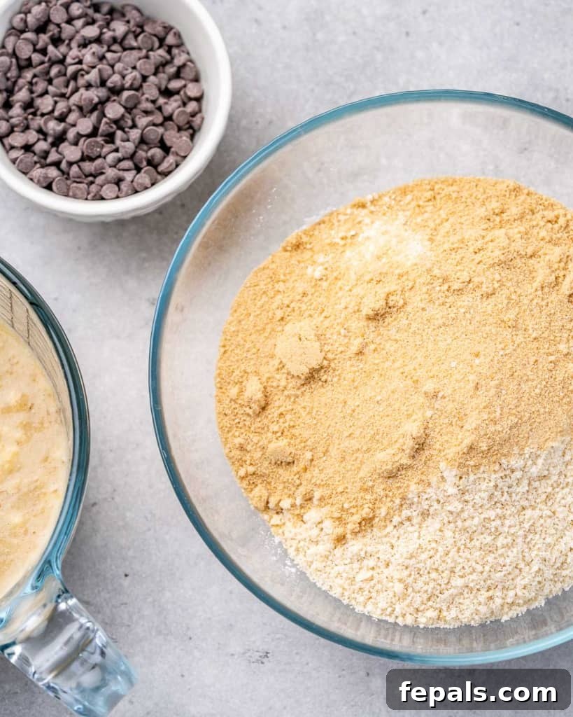 A close-up view of a bowl containing a mixture of oat flour and almond flour, ready for mixing with other dry ingredients.