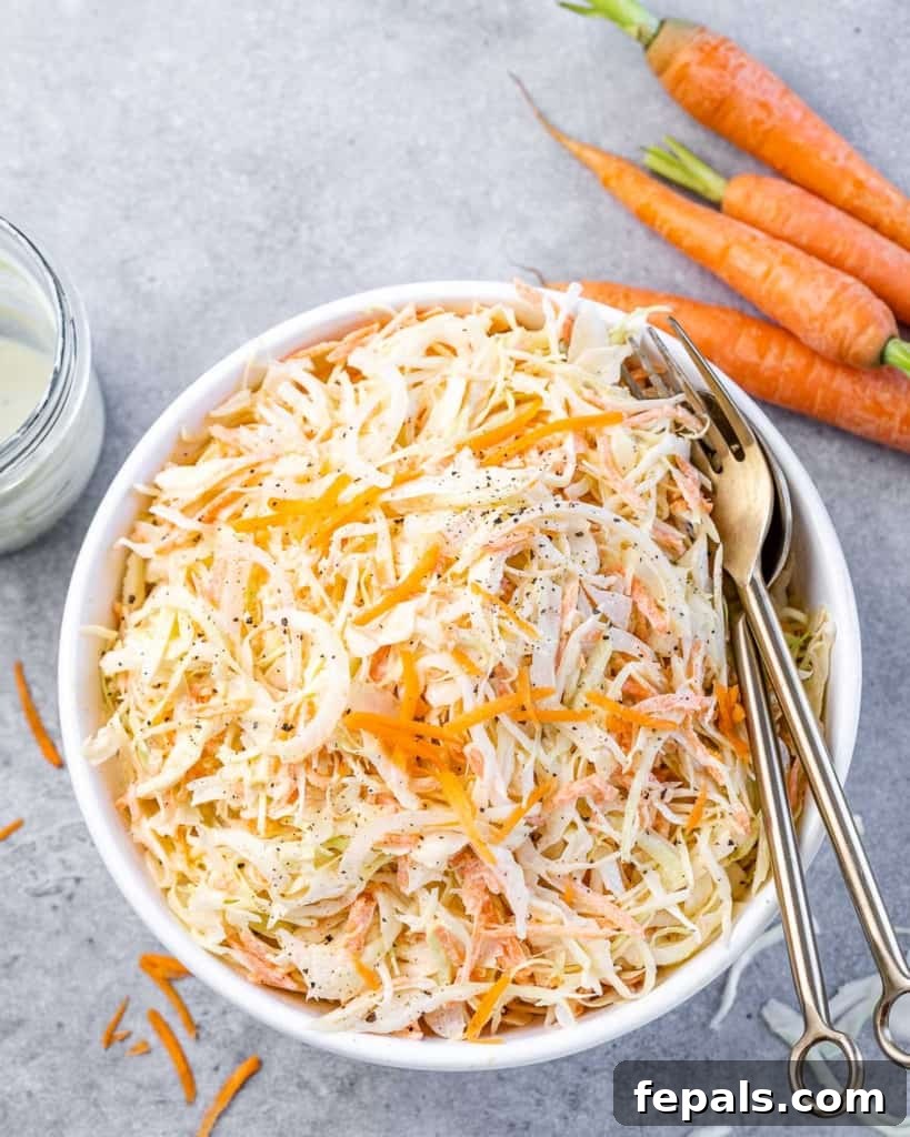 Wholesome Homemade Coleslaw 8 top view of healthy coleslaw in a bowl with utensils in bowl