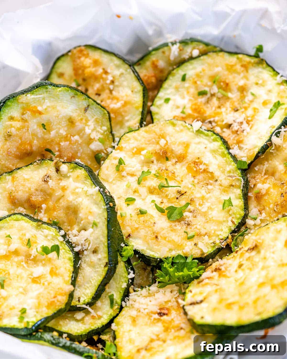 Zucchini Chips up close image of baked zucchini chips with parmesan