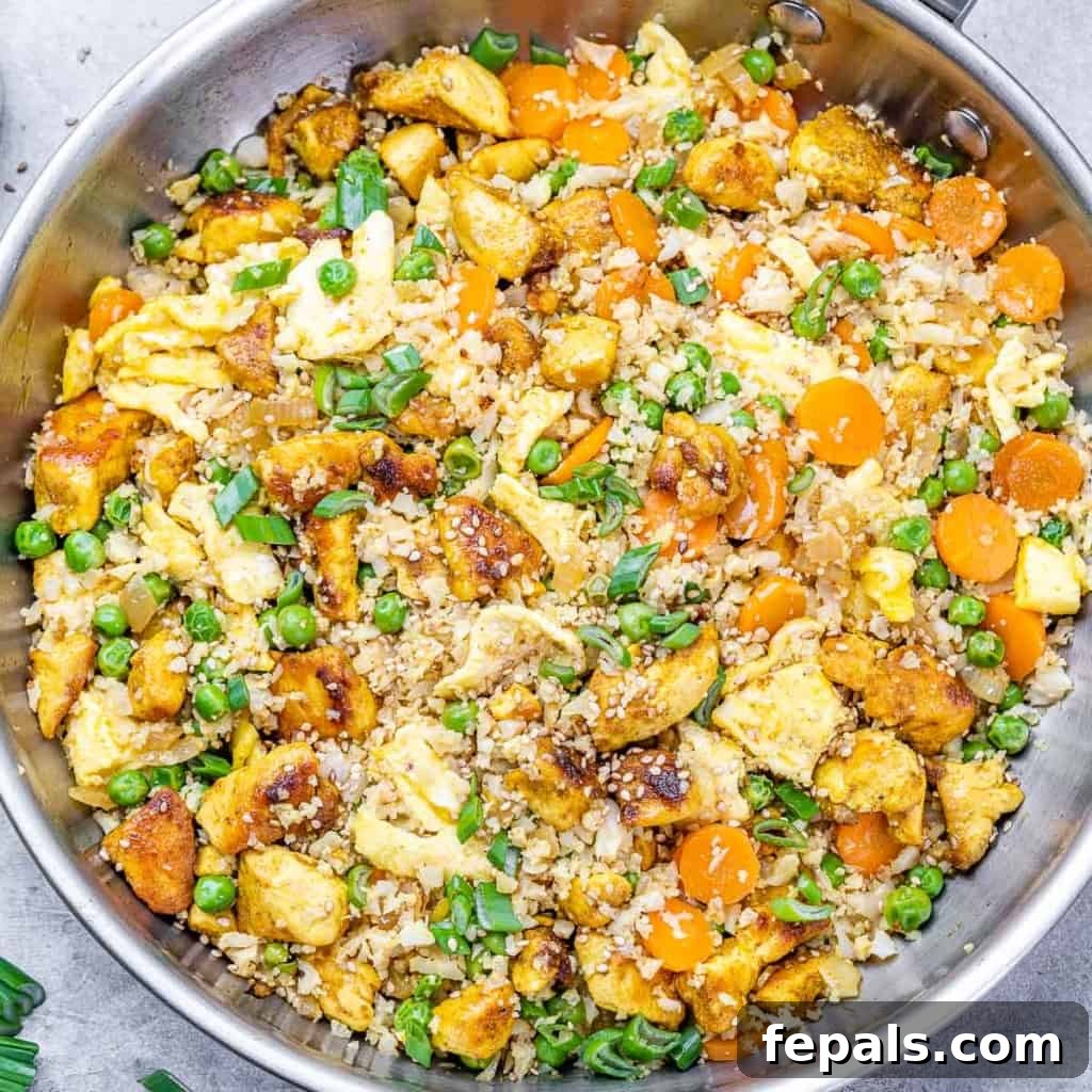 Close-up, top view of chicken cauliflower fried rice in a silver pan, ready to serve