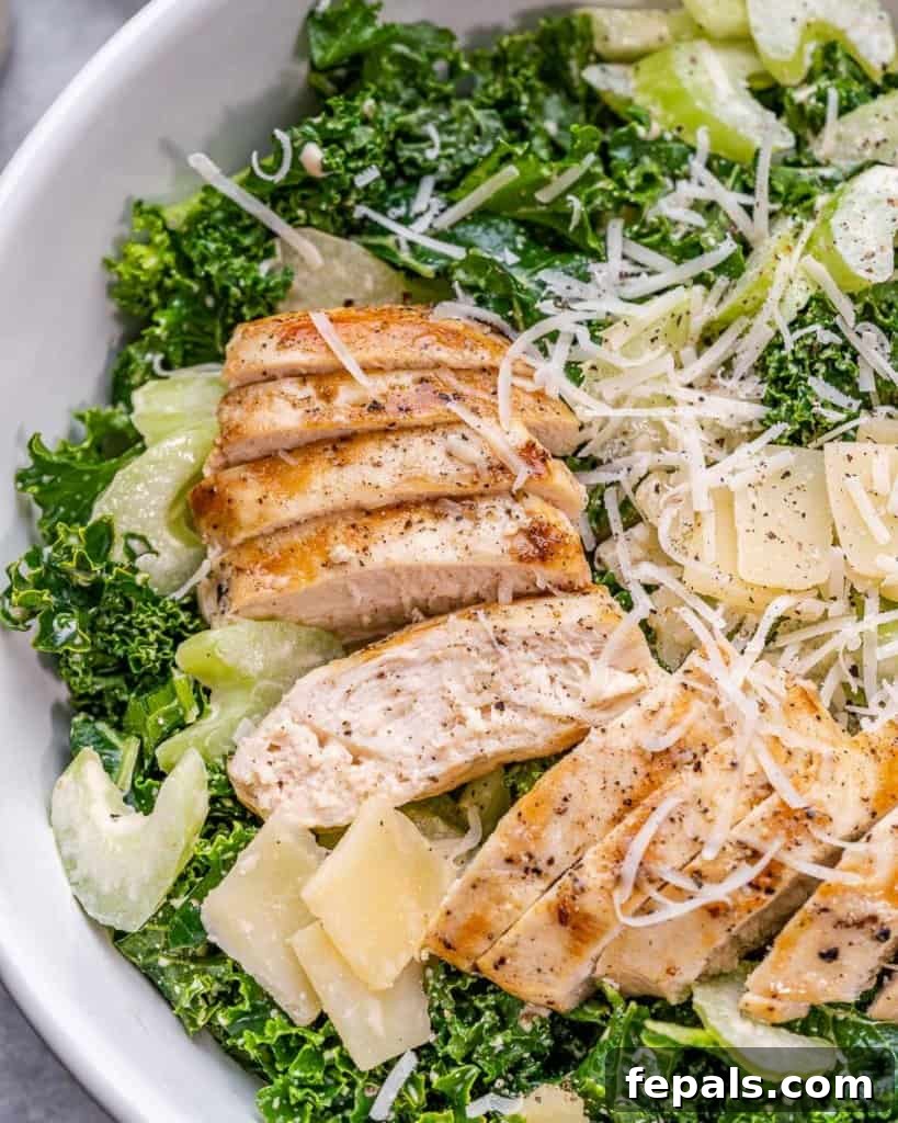 Flame-Kissed Chicken Kale Caesar 3 close up view of sliced chicken breast over kale salad topped with parmesan cheese