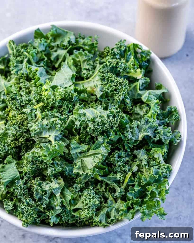 Flame-Kissed Chicken Kale Caesar 6 kale leaved in a white bowl