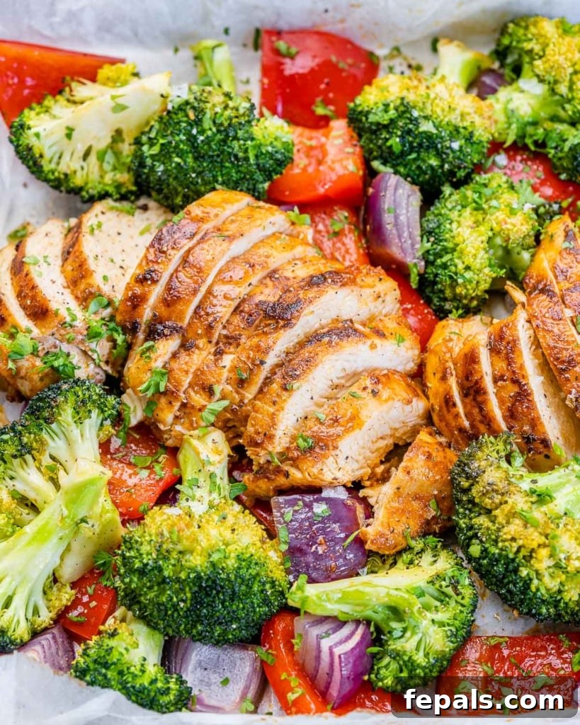 side shot of sliced chicken breast with roasted veggies 