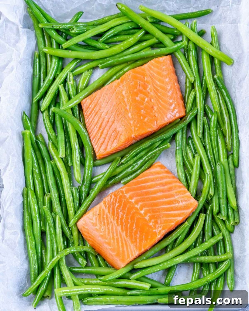 two salmon filets with green beans on pan