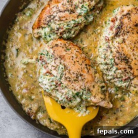 A close-up of a cooked Italian stuffed chicken breast, showcasing its golden-brown exterior and creamy filling, freshly prepared