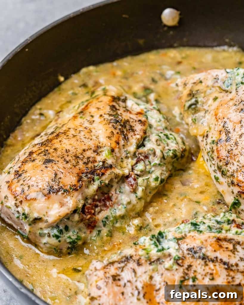Tuscan Cheese-Stuffed Chicken 9 A side profile shot of a perfectly cooked Italian stuffed chicken breast, showcasing its appealing texture and golden crust in a skillet.