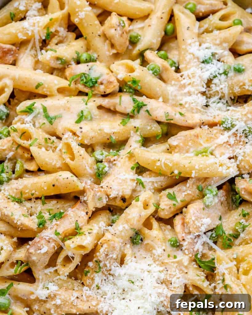 Lighter Chicken Carbonara 3 Close-up of creamy chicken pasta garnished with fresh parsley.
