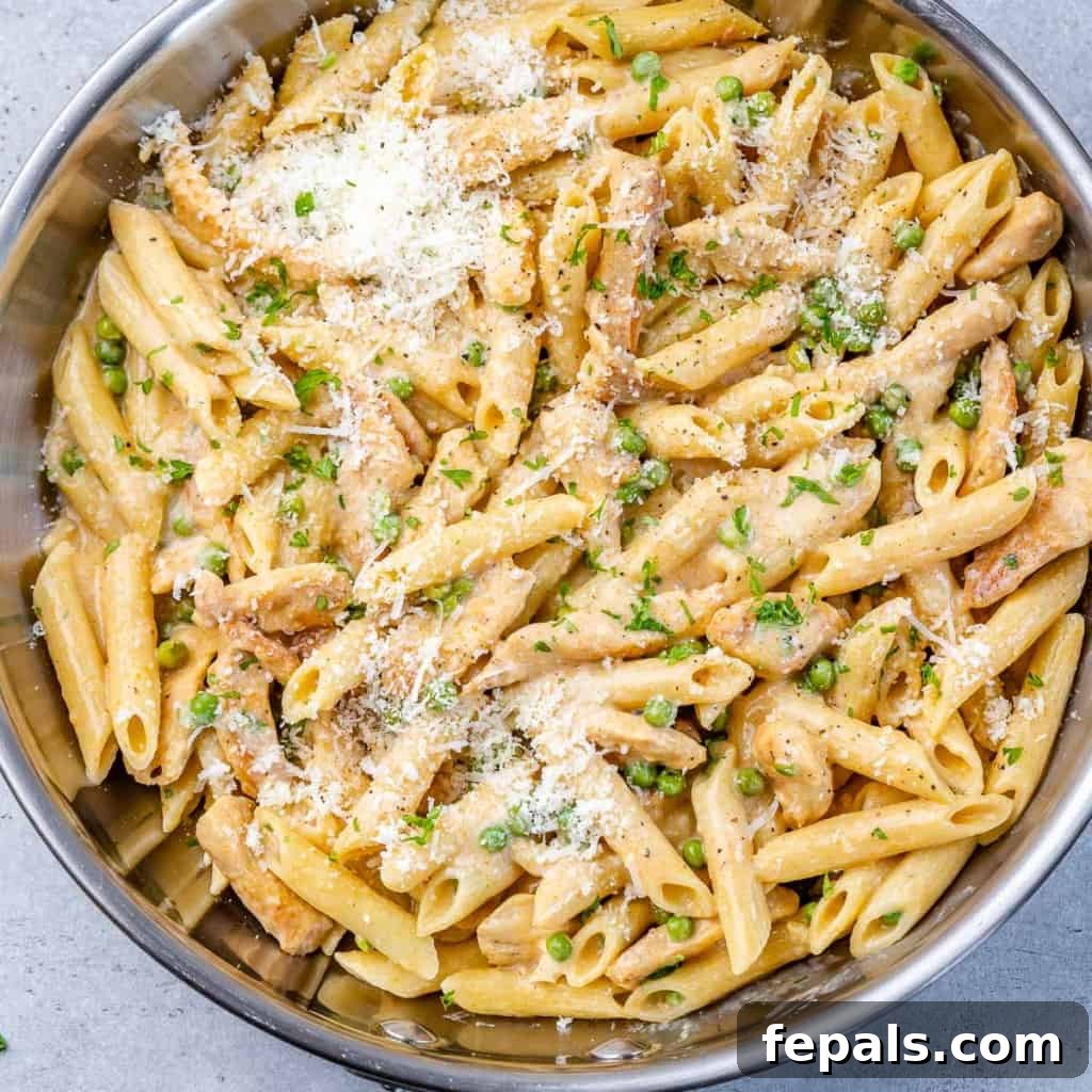 Lighter Chicken Carbonara 9 Top view of creamy chicken carbonara pasta served in a silver pan, ready to eat.
