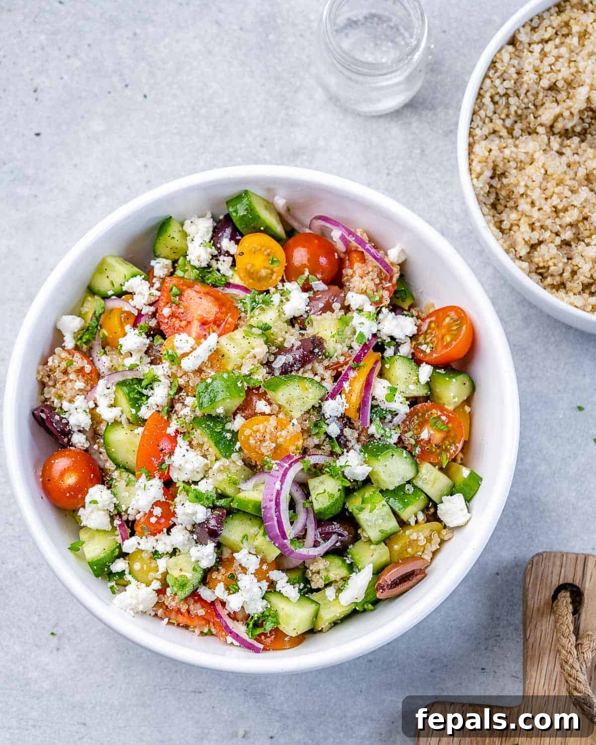Vibrant Mediterranean Quinoa Salad 8 Tossed Mediterranean quinoa salad artfully arranged in a circular white bowl.