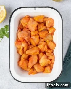 chicken chunks seasoned in a bowl before cooking
