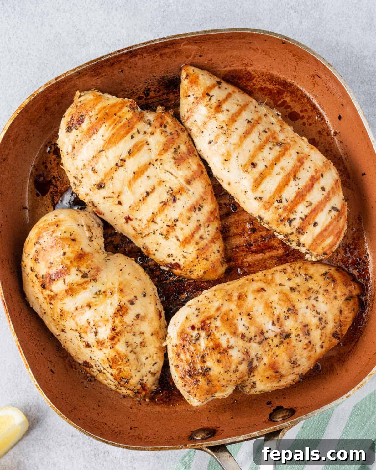 Juicy Italian Grilled Chicken Breasts 8 Four Italian chicken breasts grilling simultaneously on a large grill pan, displaying perfect charring.