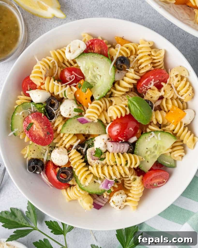 Zesty Italian Pasta Salad 11 Top view of a single serving of Italian pasta salad on a white plate, ready to be enjoyed.