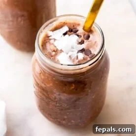 Chocolate overnight oats in a jar topped with coconut flakes and chocolate chips