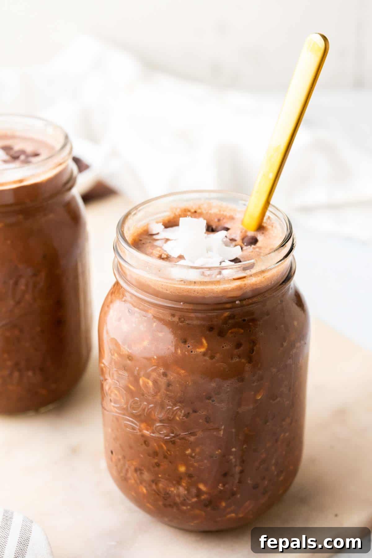 One jar of chocolate peanut butter overnight oats with a spoon inserted, ready to be enjoyed