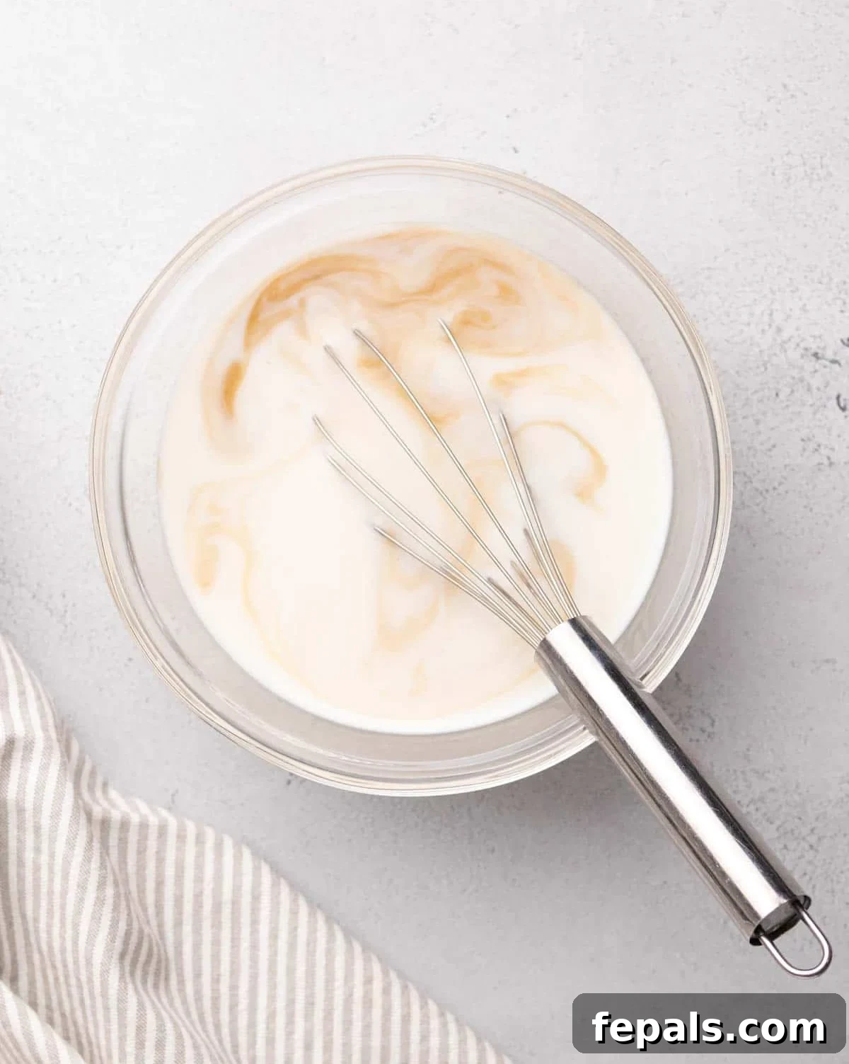 milk whisked in a bowl