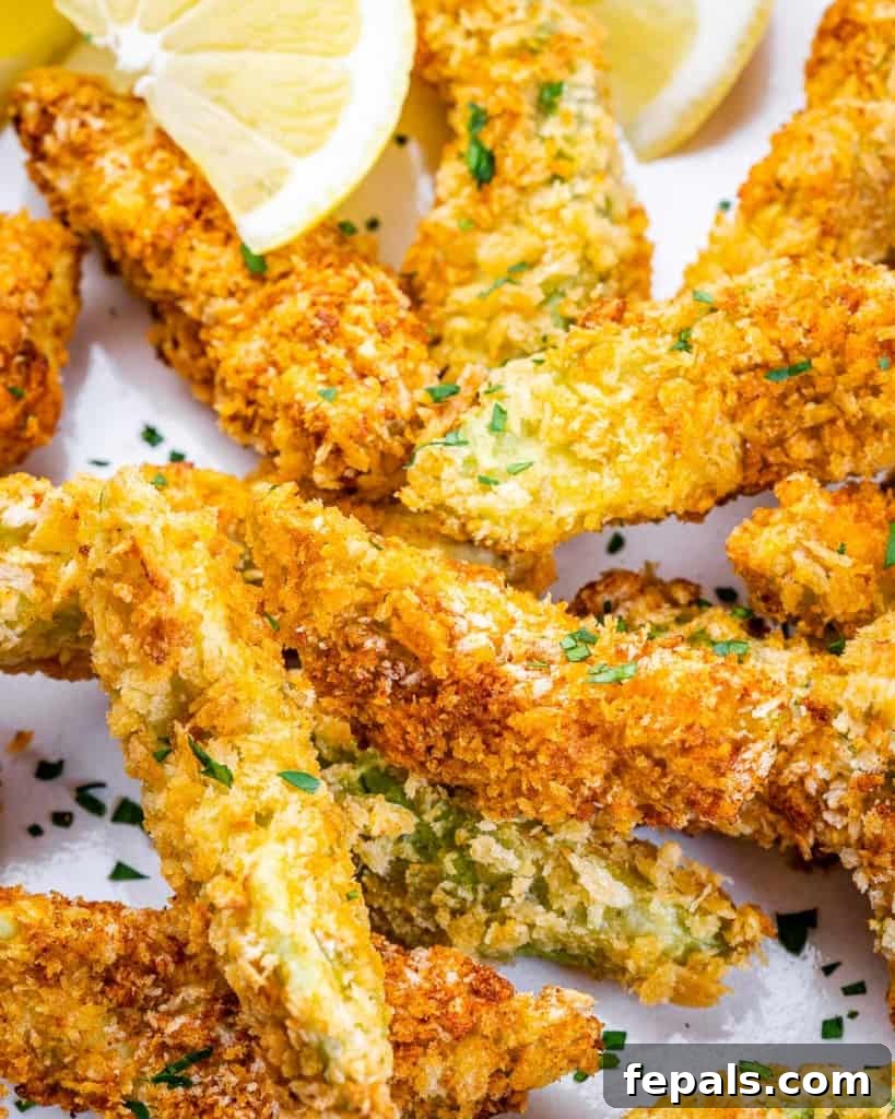 Avocado Golden Fingers 3 close up of crispy baked avocado fries on a plate, showing the vibrant green interior