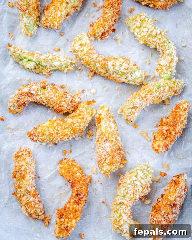 Avocado Golden Fingers 5 baked avocado fries on a baking tray, fresh out of the oven