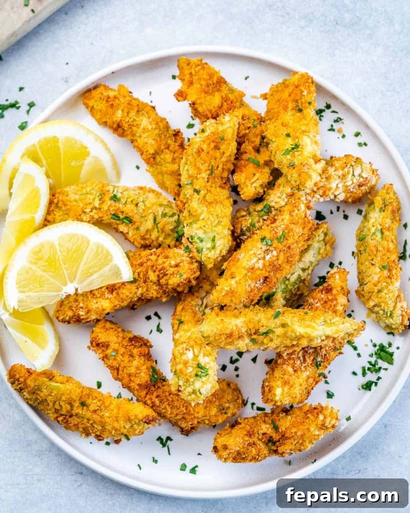 Avocado Golden Fingers 7 close up of crispy baked avocado fries on a white plate, showing the golden breading