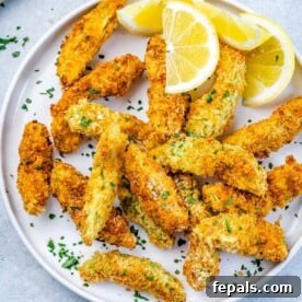 Avocado Golden Fingers 9 top view of baked avocado fries on a white plate