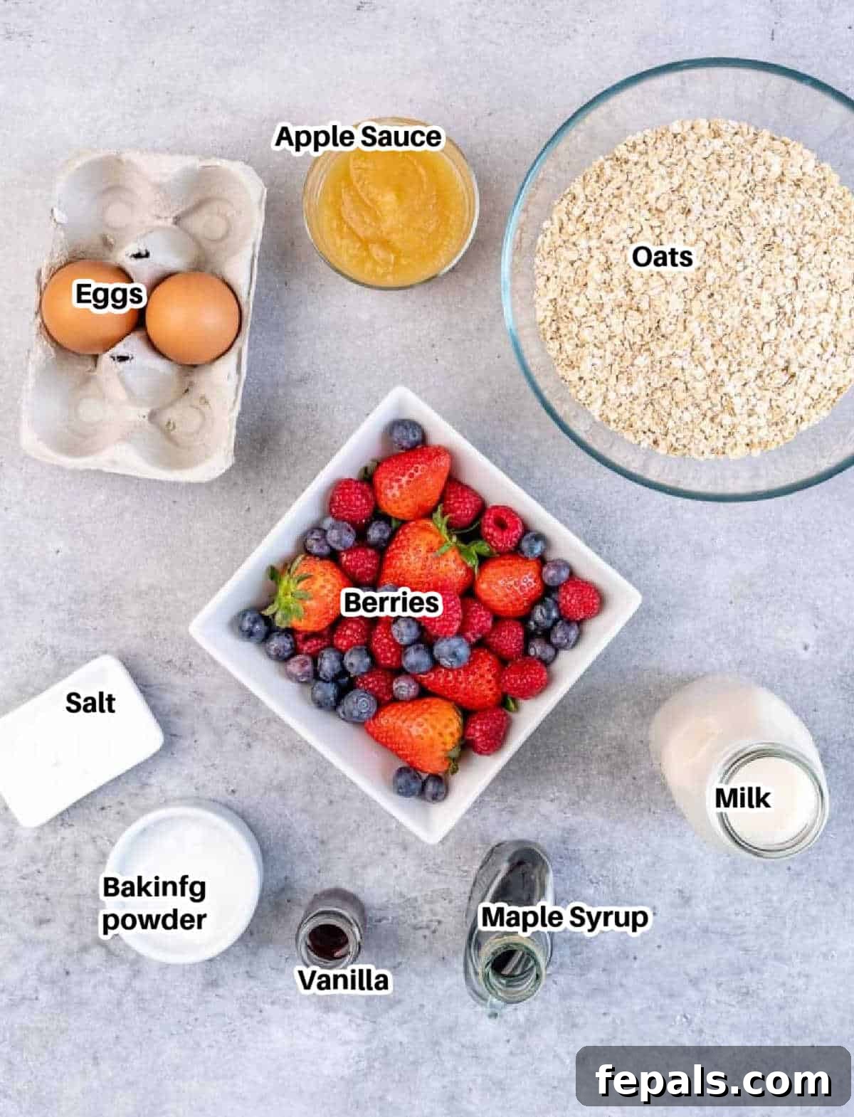A visually appealing flat lay showcasing all the fresh and pantry staple ingredients needed to prepare the delicious berries-baked oatmeal, neatly arranged for preparation.
